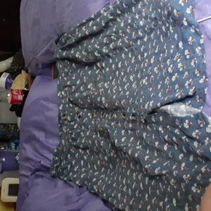 Knee length blue skirt with floral design and faux buttons elastic waist band